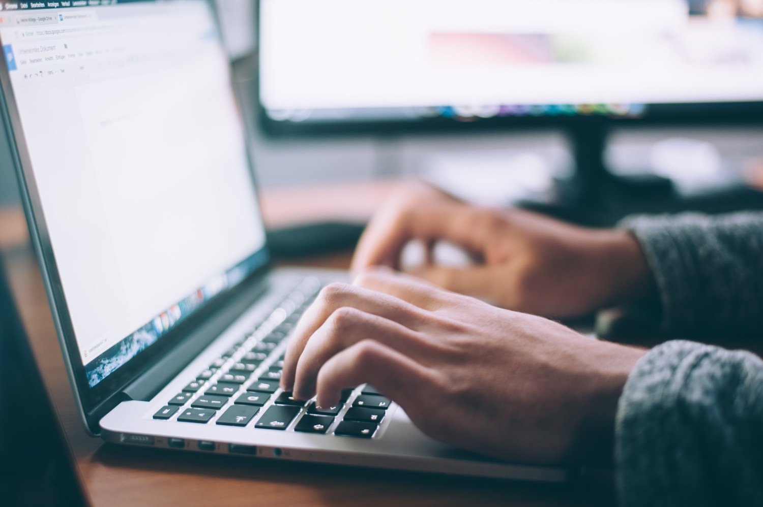 grief-articles-post hands typing on a keyboard